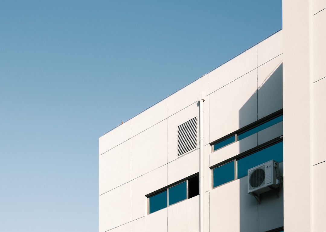 white-concrete-building-under-blue-sky-during-daytime-dik8n8wyytw
